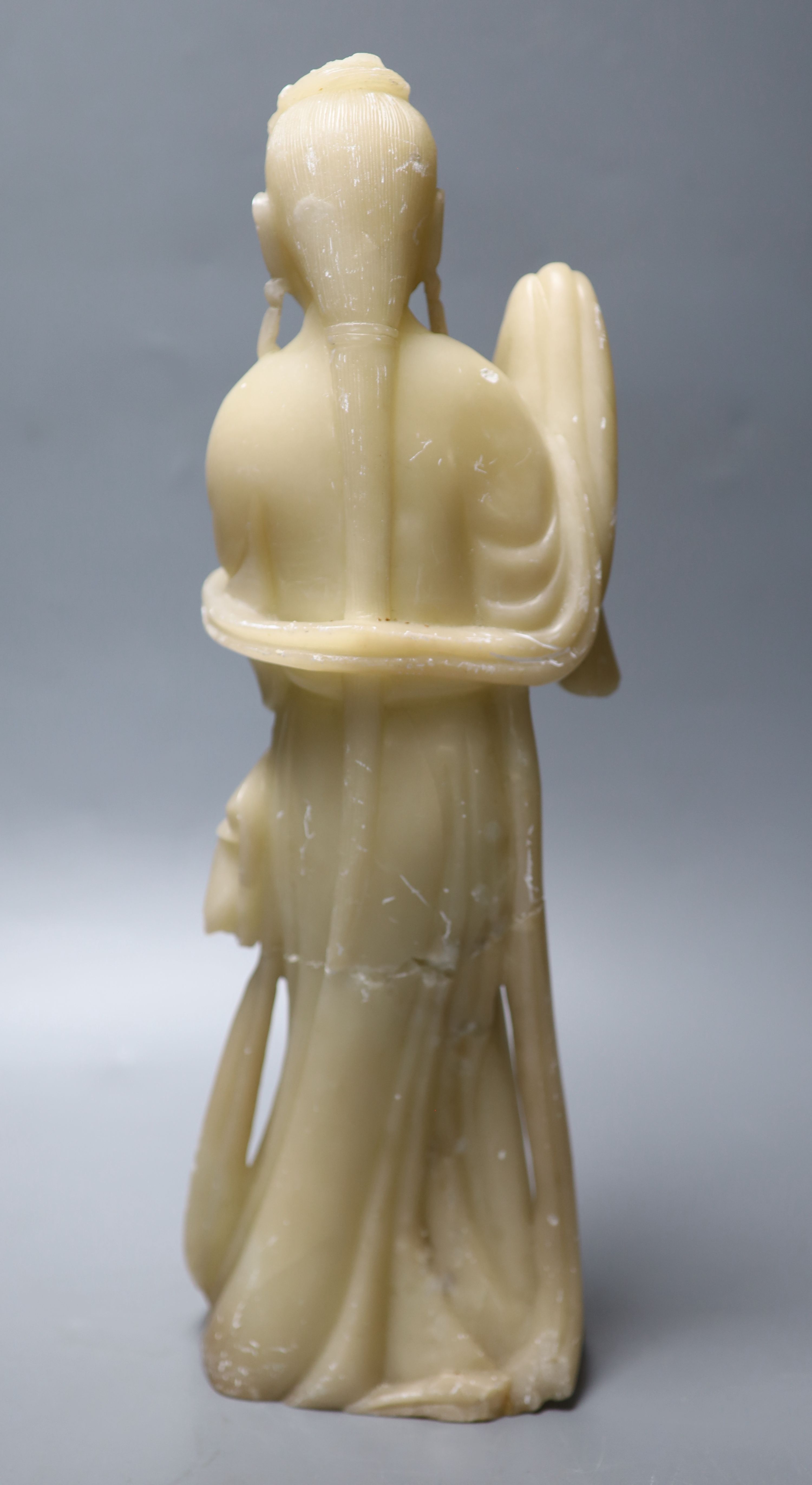 A large Chinese cream soapstone figure of an immortal, 41.5cm, (damaged) and a smaller 19th century Chinese russet soapstone figure of